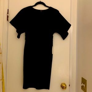 This stylish black dress has sexy bell sleeves and a plunging V neckline.